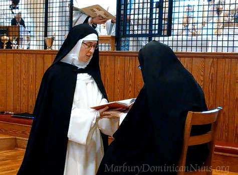 Photo of Sister Mary Rose professing her Solemn Vows in the hands of the prioress.